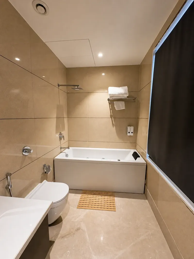 Bathroom with Jacuzzi: italian marble tiling surrounds a full jacuzzi tub. Hotel Silk by Resham, Murthal, Haryana.