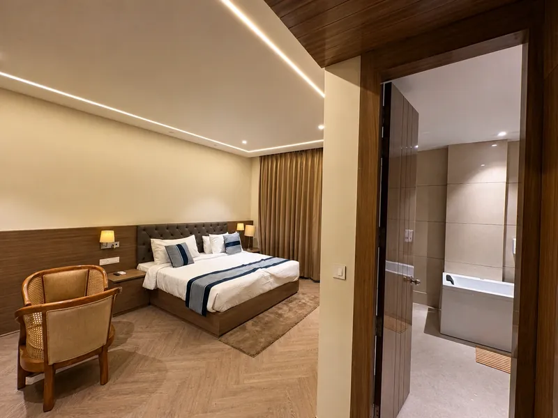 Bedroom & Ensuite Bath: the bedroom opens directly onto a marble-clad soaking tub. Hotel Silk by Resham, Murthal, Haryana.