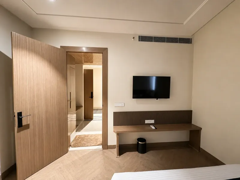 Room Entry & Wardrobe: herringbone flooring and PU-finished joinery at the entry. Hotel Silk by Resham, Murthal, Haryana.